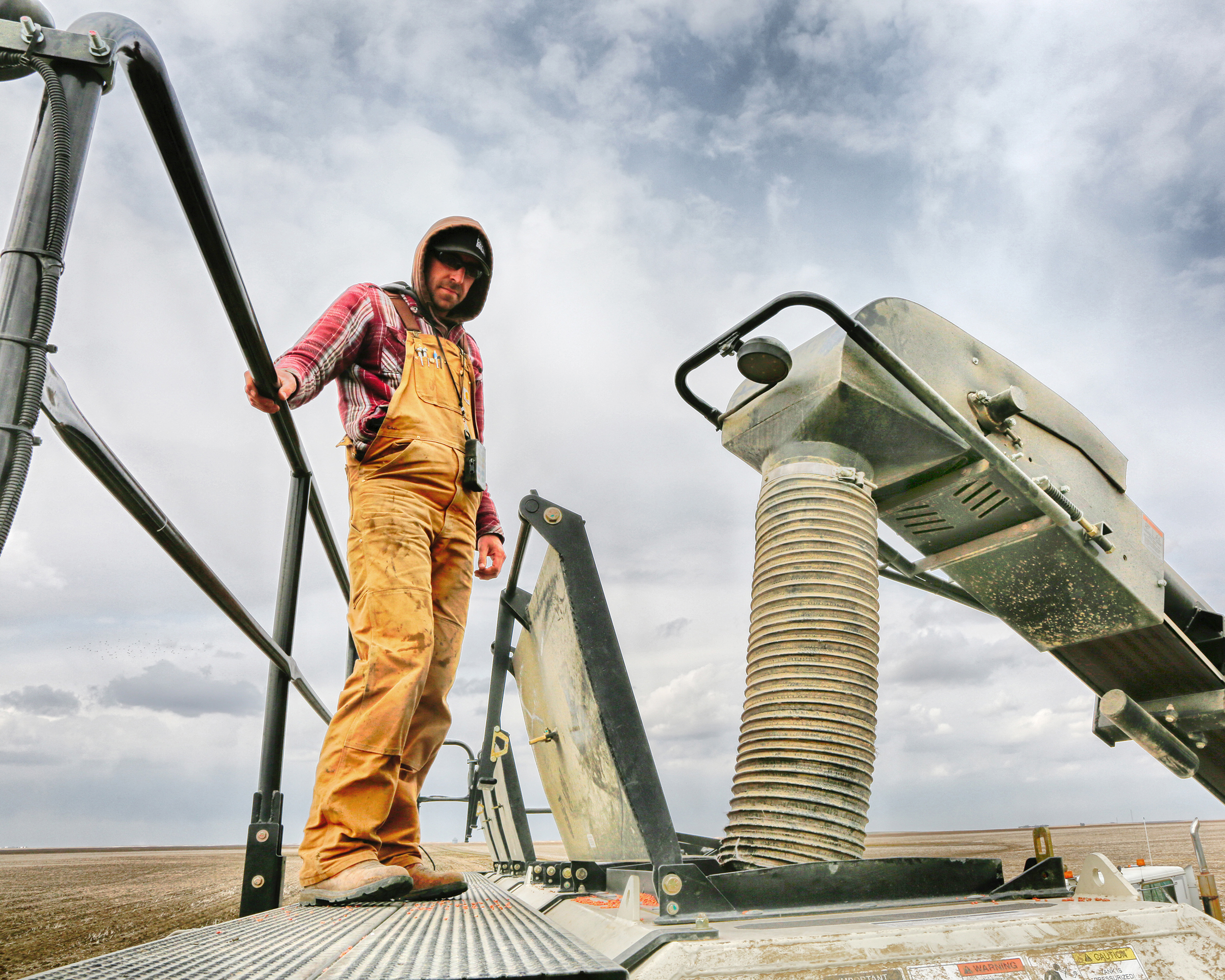 Farmer working on grain handling equipment